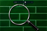 Magnifying glass on a green tiled background with zoom control overlay